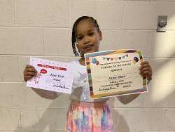 Little Girl with her awards in our Educational Program in Decatur, AL